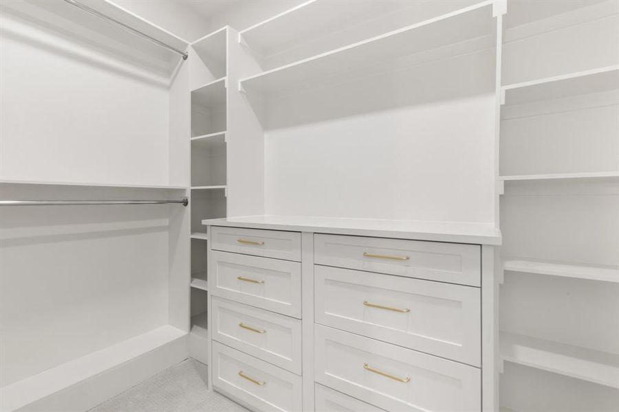 Spacious closet with light colored carpet