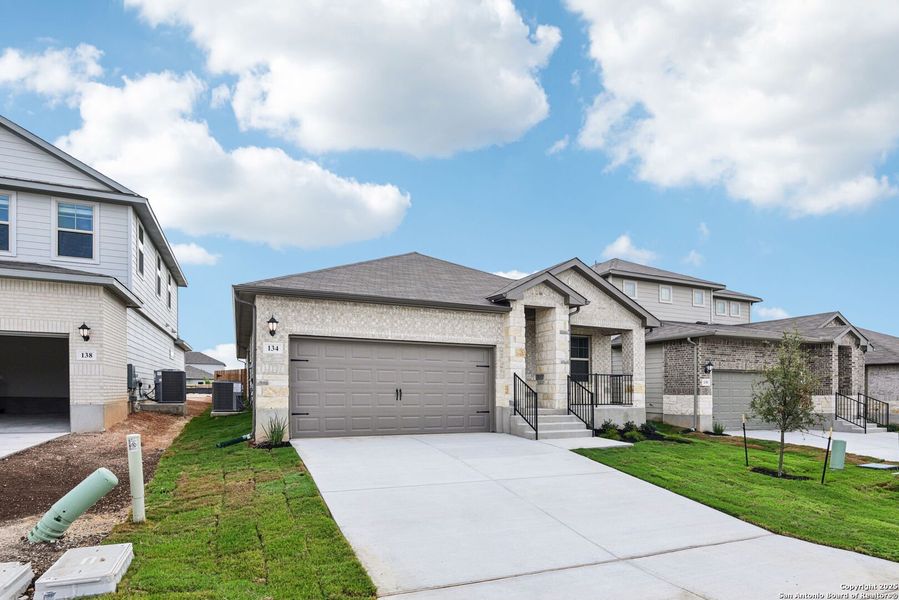 Front exterior of a new home in Legendary Trails - Premier Series, Cibolo, TX, highlighting curb appeal (Image 21). Front exterior of a new home in Legendary Trails - Premier Series, Cibolo, TX, highlighting curb appeal (Image 21).