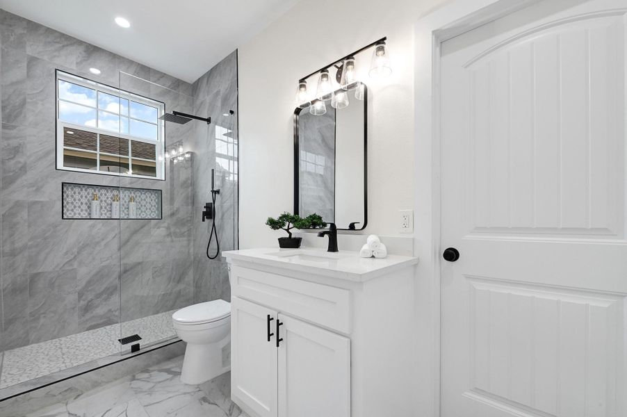 Sleek master bathroom with elegant finishes and a spacious walk-in shower. Sleek master bathroom with elegant finishes and a spacious walk-in shower.