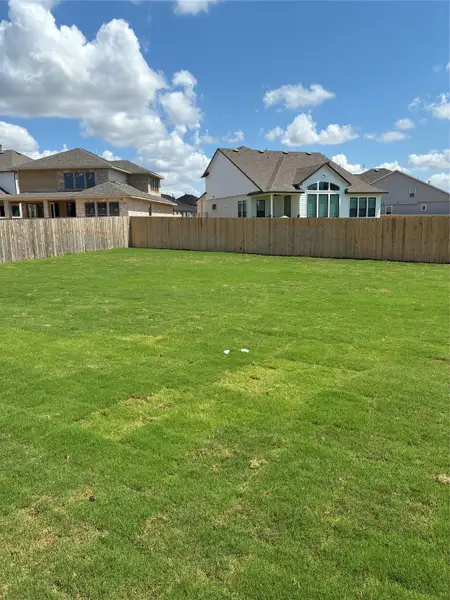 Front exterior of a new home in Santa Rita Ranch, Liberty Hill, TX, highlighting curb appeal (Image 1). Front exterior of a new home in Santa Rita Ranch, Liberty Hill, TX, highlighting curb appeal (Image 1).