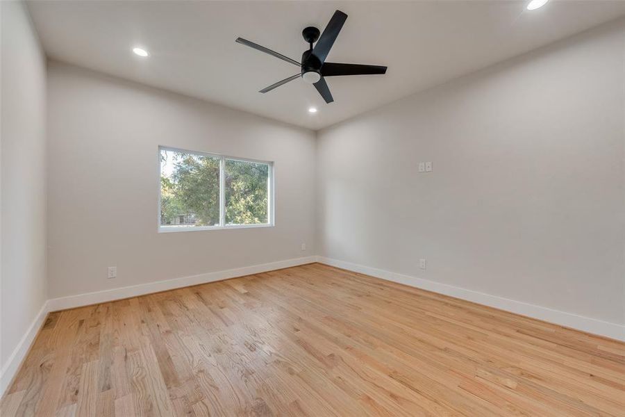 Empty room featuring light hardwood / wood-style flooring and ceiling fan