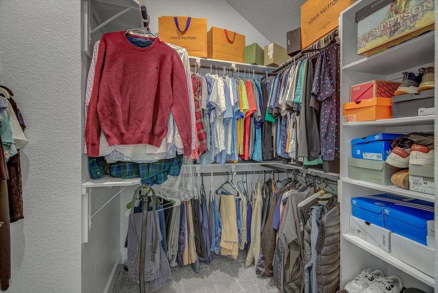 His spacious closet offers upper and lower hanging rails, complemented by curated shelving ideal for displaying shoes, hats etc..