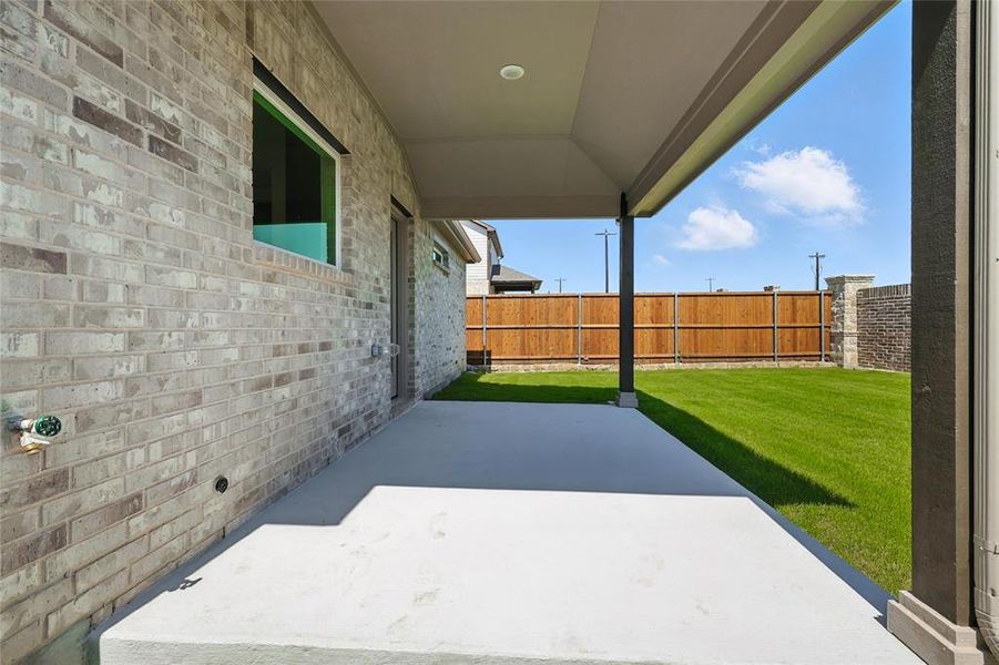 Fenced backyard featuring a patio area Fenced backyard featuring a patio area