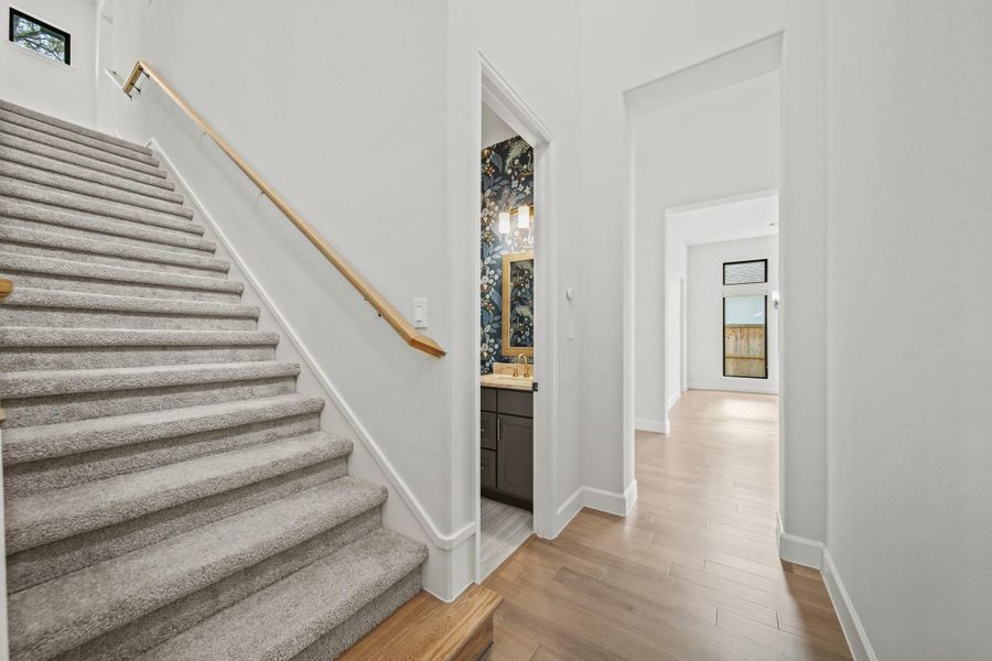 Stairs up to LARGE gameroom and 1/2 bath upstairs. The powder room on the first floor is shown in this picture too! Stairs up to LARGE gameroom and 1/2 bath upstairs. The powder room on the first floor is shown in this picture too!