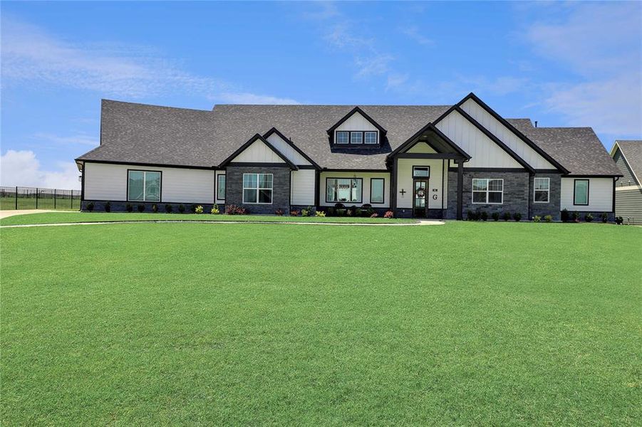 View of front of property with stone siding and roof with shingles View of front of property with stone siding and roof with shingles