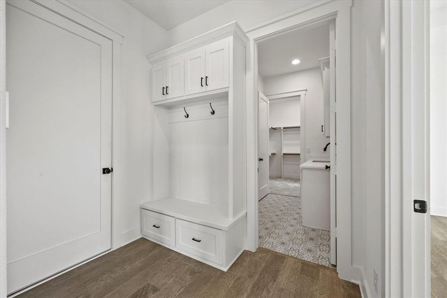 Mudroom with dark hardwood / wood-style flooring and sink