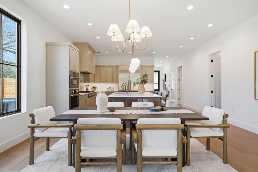 Dining room featuring light wood finished floors and a chandelier