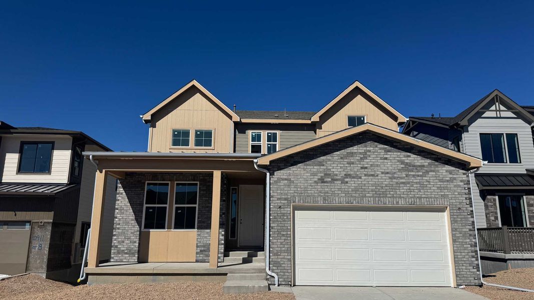 Front exterior of a new home in Legacy at Kime Ranch, Parker, CO, highlighting curb appeal (Image 1). Front exterior of a new home in Legacy at Kime Ranch, Parker, CO, highlighting curb appeal (Image 1).