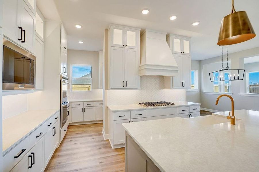 REPRESENTATIVE PHOTO: Gorgeous and functional Kitchen with quartz counters, stacked cabinets to ceiling, updraft vent hood and LOTS of cabinets and storage!