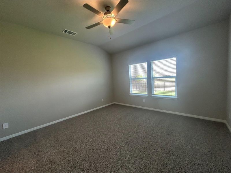 Spare room featuring carpet, ceiling fan, and lofted ceiling Spare room featuring carpet, ceiling fan, and lofted ceiling