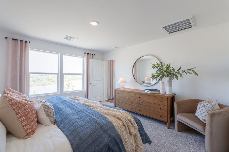 A bedroom with a bed and a mirror. A bedroom with a bed and a mirror.