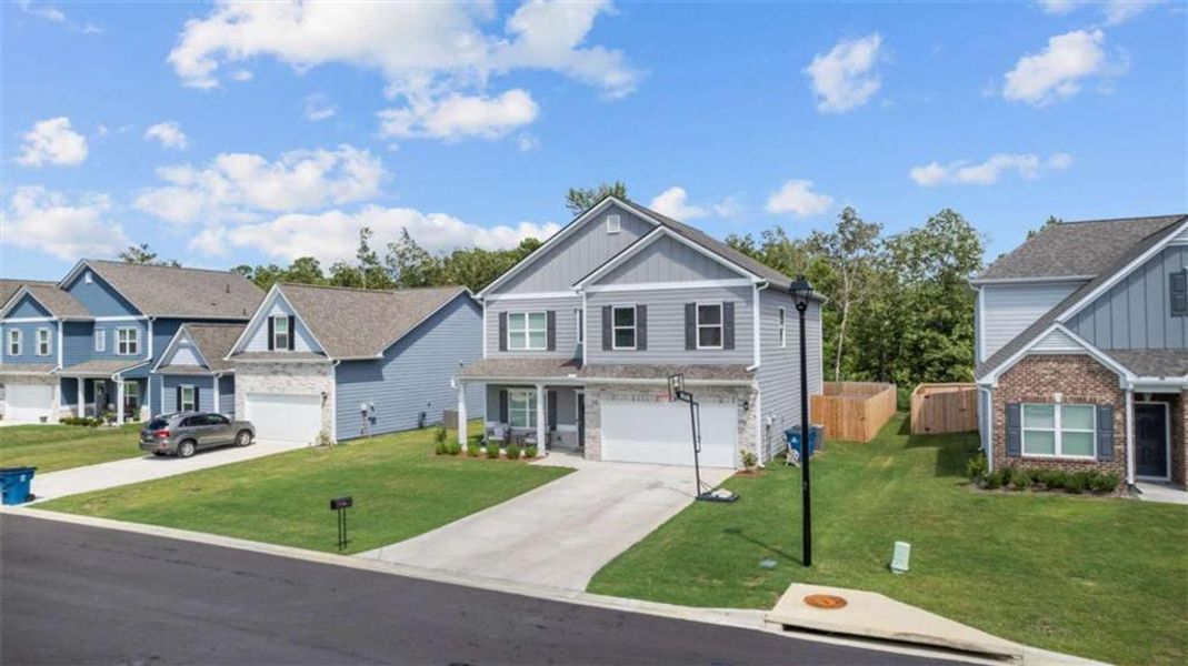 Front exterior of a new home in , Rome, GA, highlighting curb appeal (Image 1). Front exterior of a new home in , Rome, GA, highlighting curb appeal (Image 1).