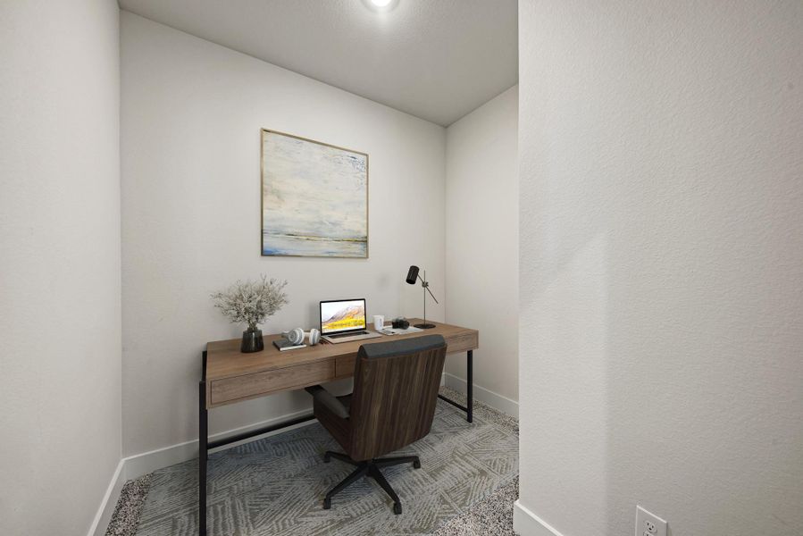 Carpeted home office with baseboards and a textured wall