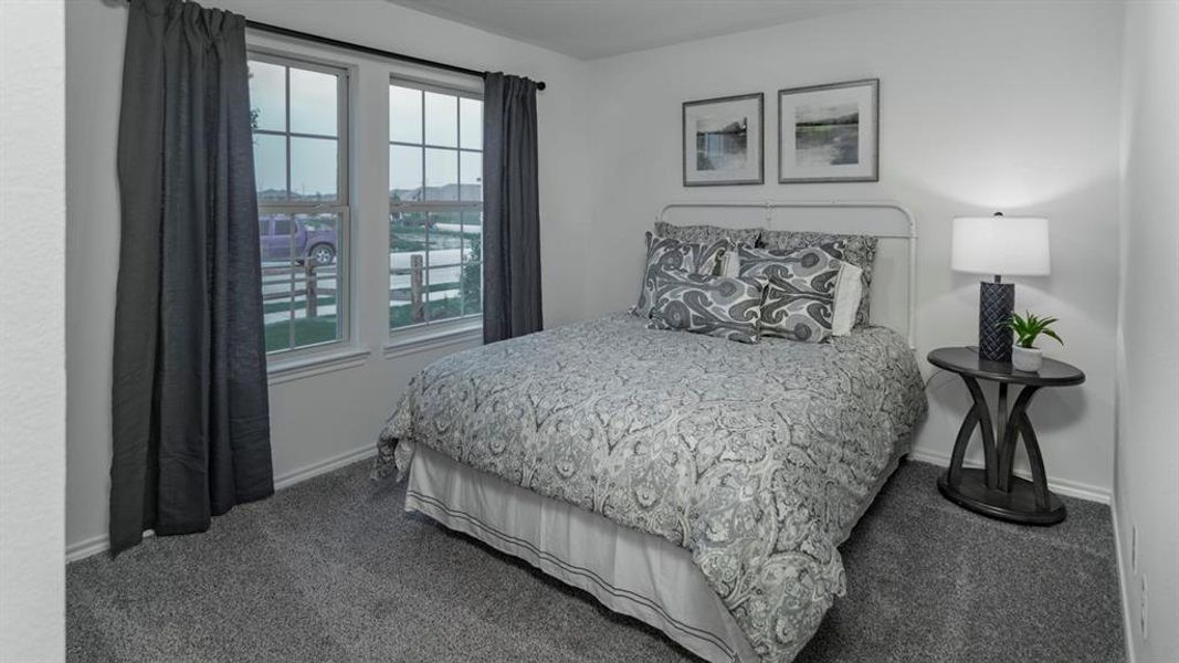 Bedroom featuring dark carpet