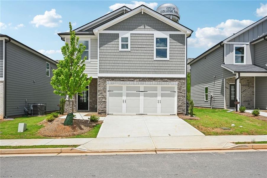 Front exterior of a new home in Hawthorne Station, College Park, GA, highlighting curb appeal (Image 23).