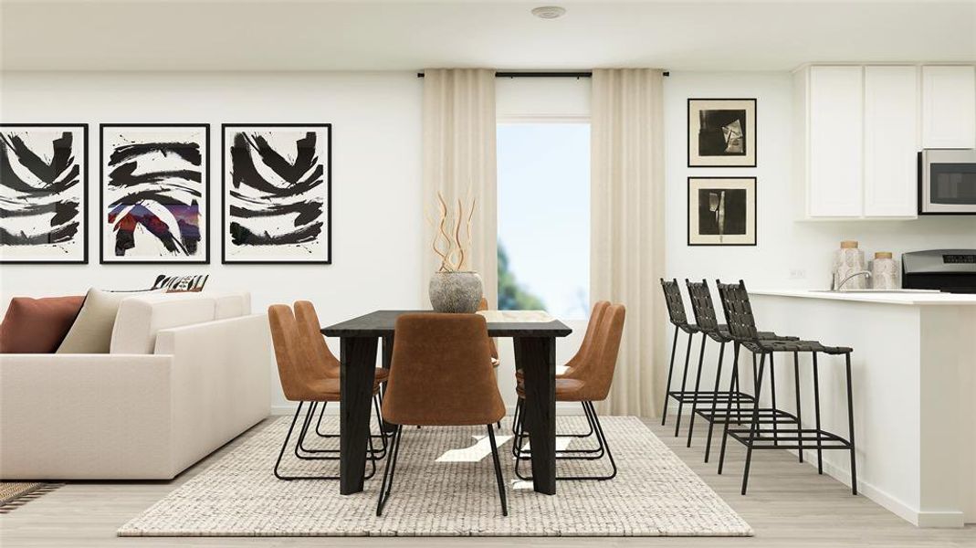 Open-concept living space featuring wood-finish flooring, a dining area with a dark-finish table, and a kitchen with white cabinetry and stainless steel appliances Open-concept living space featuring wood-finish flooring, a dining area with a dark-finish table, and a kitchen with white cabinetry and stainless steel appliances