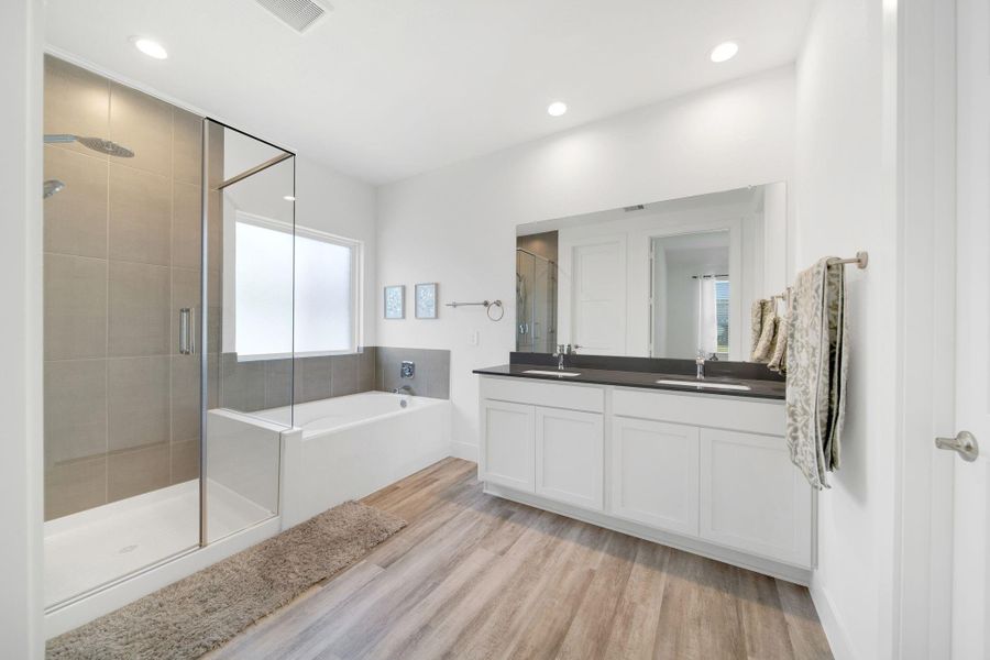 The primary ensuite feels like your own personal spa, complete with a soothing vibe, a spacious walk-in shower, and a separate soaking tub perfect for unwinding.