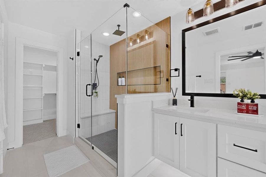 Modern bathroom featuring a glass-enclosed shower with a wood-finish accent wall, built-in bench, and rain showerhead