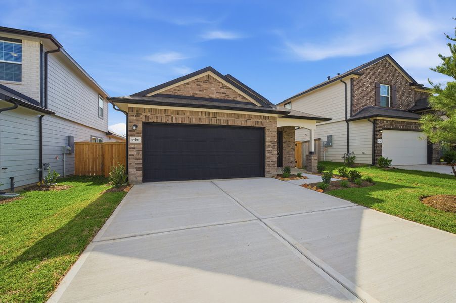 Front exterior of a new home in The Pines at Seven Coves, Willis, TX, highlighting curb appeal (Image 2).