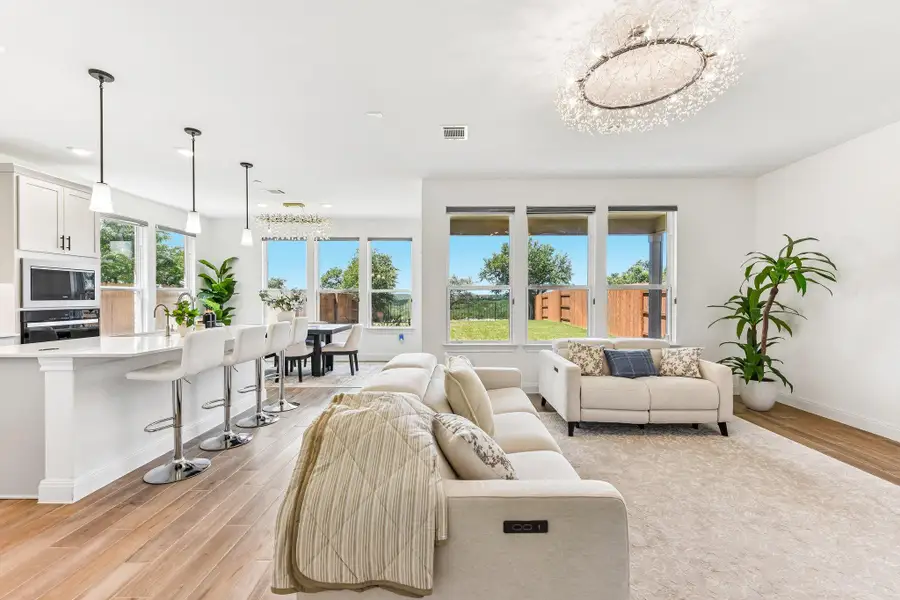 An open-concept living space with sleek flooring and natural light.