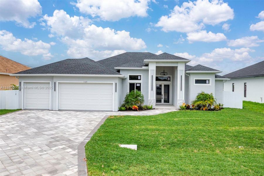 Front exterior of a new home in , Cape Coral, FL, highlighting curb appeal (Image 29). Front exterior of a new home in , Cape Coral, FL, highlighting curb appeal (Image 29).