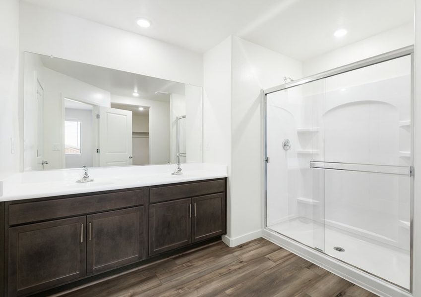 The master bathroom holds a glass-enclosed shower.