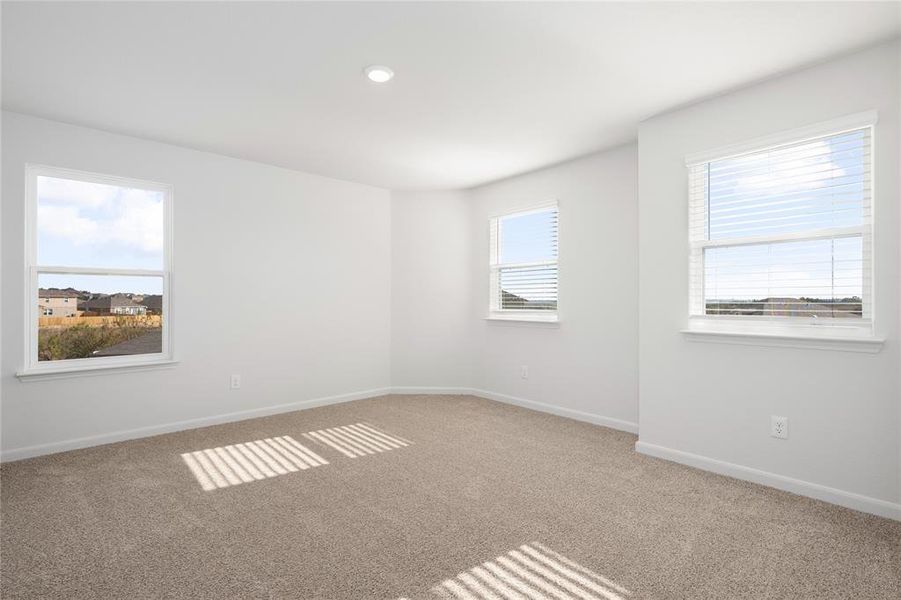 Carpeted spare room with baseboards