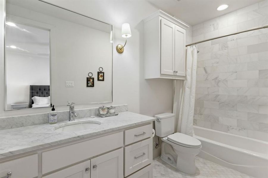 Bathroom with shower / bath combination with curtain, vanity, and toilet Bathroom with shower / bath combination with curtain, vanity, and toilet