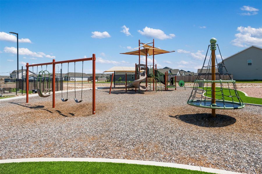 A well-equipped community playground features multiple play structures, swings, and climbing elements under sunny skies. A well-equipped community playground features multiple play structures, swings, and climbing elements under sunny skies.