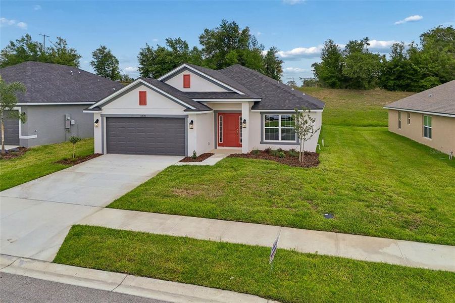 Front exterior of a new home in Abbey Glen, Dade City, FL, highlighting curb appeal (Image 30).