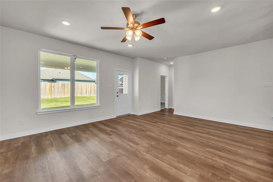 Empty room featuring recessed lighting, wood finished floors, and ceiling fan Empty room featuring recessed lighting, wood finished floors, and ceiling fan