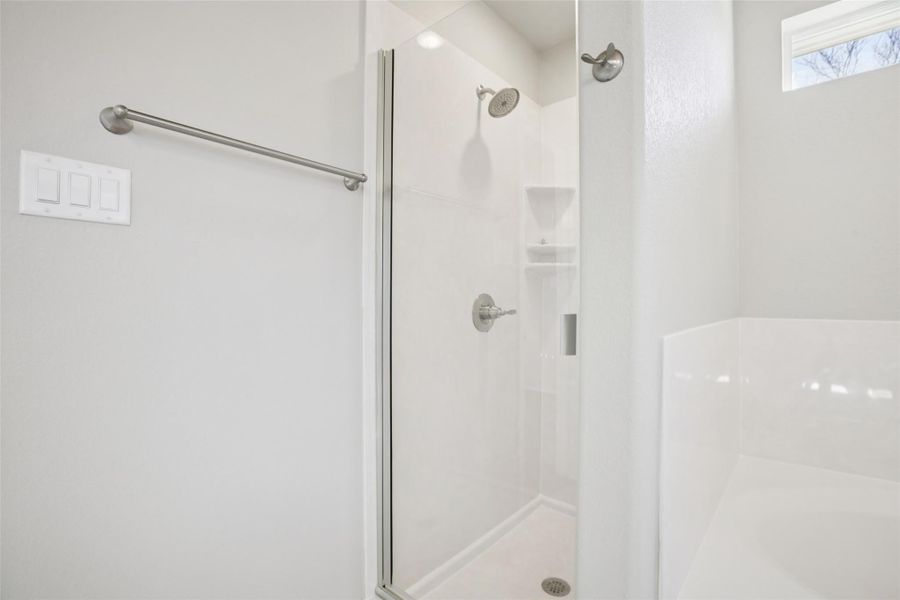 Full bathroom featuring a garden tub and a shower stall