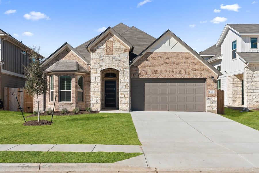 Front exterior of a new home in The Hills of Bear Creek, Manchaca, TX, highlighting curb appeal (Image 19).