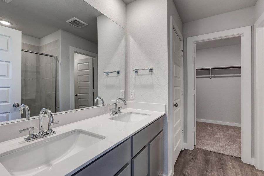A bathroom with a large mirror.