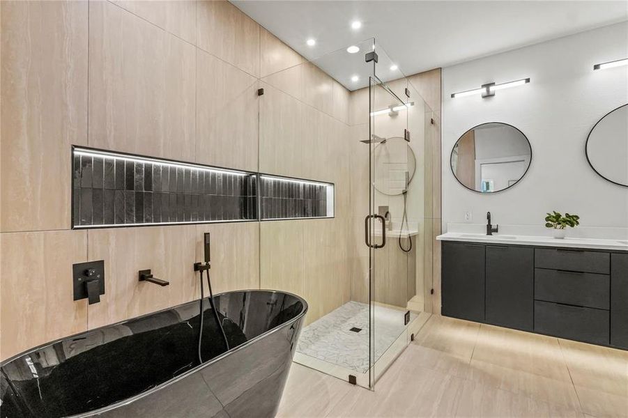 Full bathroom featuring a freestanding bath, vanity, a shower stall, recessed lighting, and tile patterned floors Full bathroom featuring a freestanding bath, vanity, a shower stall, recessed lighting, and tile patterned floors