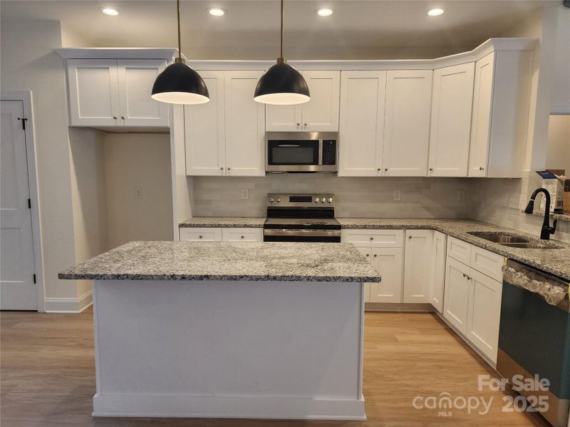 Island Kitchen - Granite counters, stainless microwave, range, and dishwasher