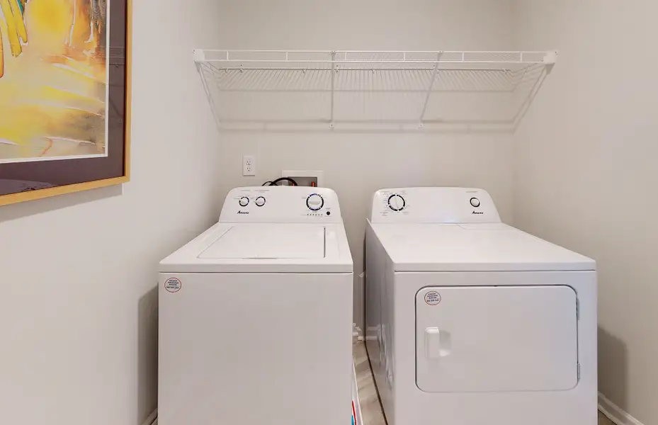 A dedicated laundry room with storage space to organize cleaning supplies.