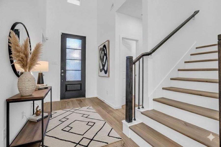 Let's head upstairs! Gain perspective with this (Virtually Staged) Entryway: This image is digitally staged to help visualize scale, layout, and design potential. The spacious foyer showcases soaring ceilings, modern stair detailing, and a flexible canvas ready to reflect your personal style. Let's head upstairs! Gain perspective with this (Virtually Staged) Entryway: This image is digitally staged to help visualize scale, layout, and design potential. The spacious foyer showcases soaring ceilings, modern stair detailing, and a flexible canvas ready to reflect your personal style.