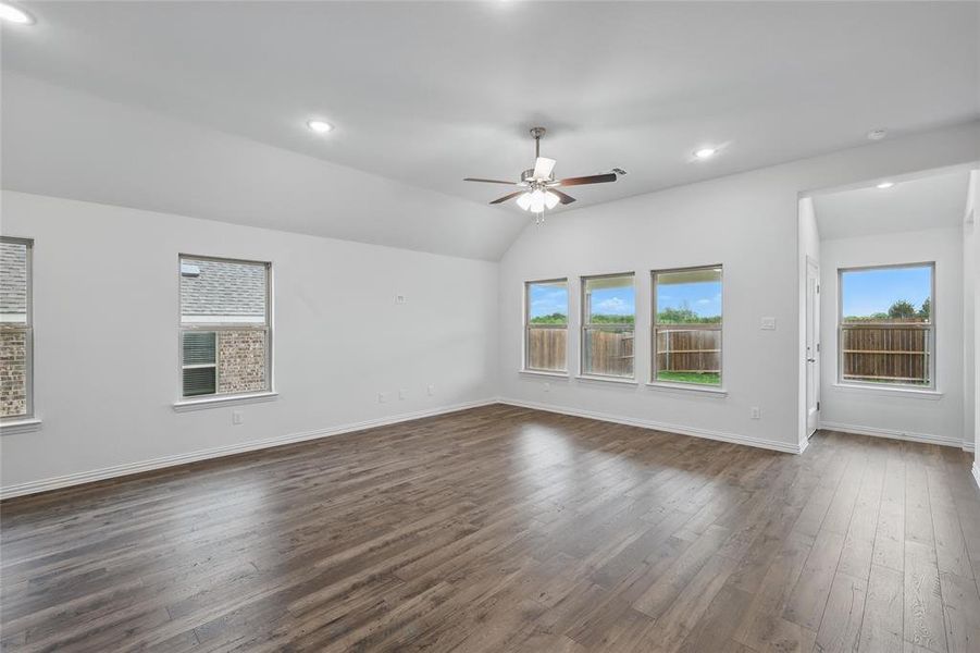 Unfurnished room featuring ceiling fan, recessed lighting, baseboards, lofted ceiling, and dark wood-style floors Unfurnished room featuring ceiling fan, recessed lighting, baseboards, lofted ceiling, and dark wood-style floors