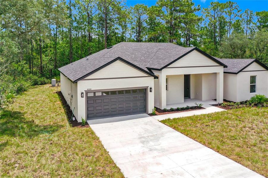 Front exterior of a new home in , Eustis, FL, highlighting curb appeal (Image 25). Front exterior of a new home in , Eustis, FL, highlighting curb appeal (Image 25).