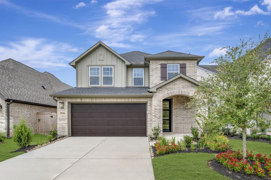 Front exterior of a new home in The Grand Prairie - Meadow Collection, Hockley, TX, highlighting curb appeal (Image 26). Front exterior of a new home in The Grand Prairie - Meadow Collection, Hockley, TX, highlighting curb appeal (Image 26).