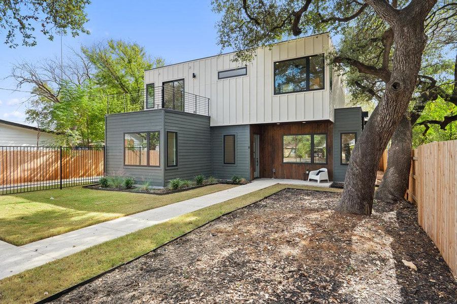 Contemporary house with a patio and board and batten siding