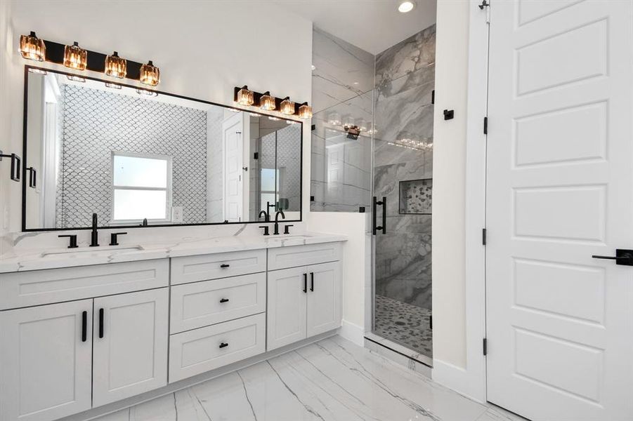 Spa-like bathroom featuring dual vanities, a soaking tub, and a walk-in shower.