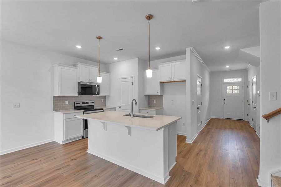 This bright kitchen features an island, ample coun This bright kitchen features an island, ample coun