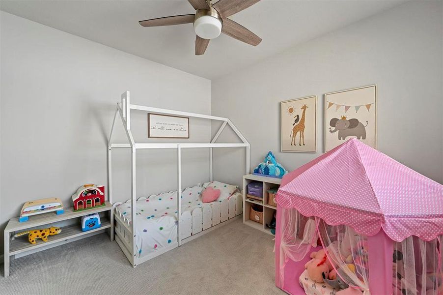 Bedroom with carpet floors and a ceiling fan Bedroom with carpet floors and a ceiling fan