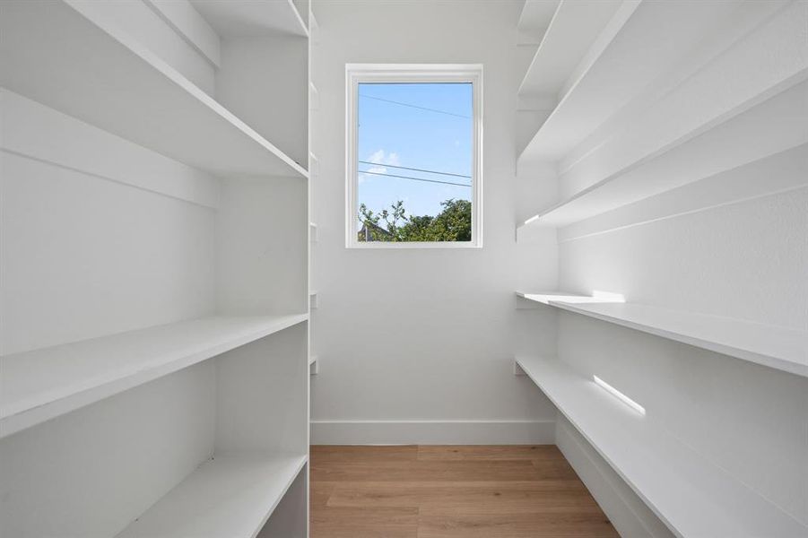 Walk in pantry with light wood-type flooring