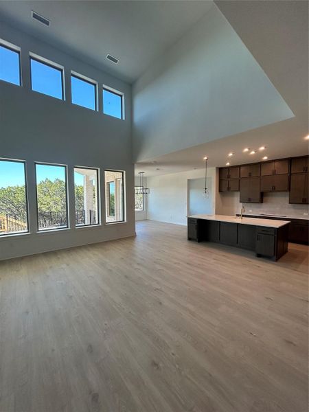 Family Room with soaring ceiling to Kitchen & Casual Dining