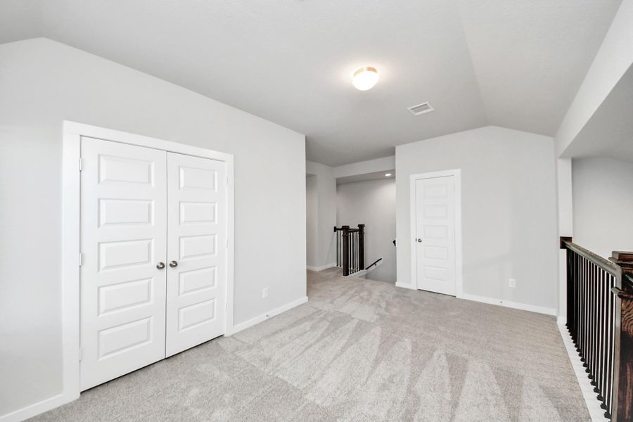 Come upstairs and enjoy a day of leisure in this fabulous game room! This is the perfect hangout spot or adult game room! Features plush carpet, high ceilings, custom paint and windows for plenty of natural light. Sample photo of completed home with similar floor plan. Actual colors and selections may vary. Come upstairs and enjoy a day of leisure in this fabulous game room! This is the perfect hangout spot or adult game room! Features plush carpet, high ceilings, custom paint and windows for plenty of natural light. Sample photo of completed home with similar floor plan. Actual colors and selections may vary.