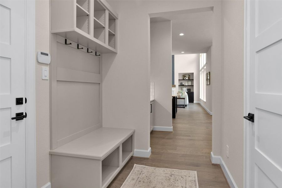 Just off the garage entry, this built-in mud bench offers a practical drop zone with cubbies, hooks and seating—perfect for keeping bags, shoes, and everyday essentials organized.