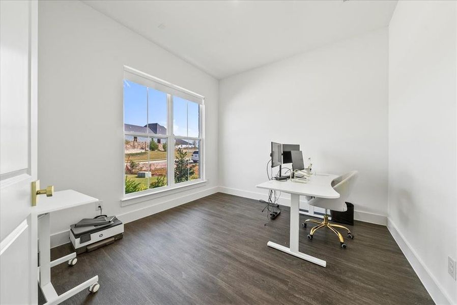 Office space featuring baseboards and wood finished floors